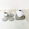 Light gray stone coasters "Drops". Set of 4 | Tableware by DecoMundo Home. Item composed of fabric & stone compatible with minimalism and modern style