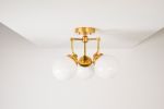 Fremont | Chandeliers by Illuminate Vintage. Item composed of brass and glass
