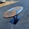 Custom Walnut Epoxy Oval Dining Table | Tables by Ironscustomwood. Item made of walnut & metal