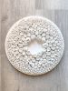 White wall sculpture on a 14" round canvas, wreath art | Wall Hangings by Natasha Kanevski. Item composed of wood & fabric compatible with minimalism and contemporary style