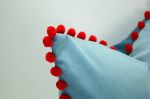 blue velvet pillow with red pom poms // blue and red pillow | Pillows by Velvet Fringe