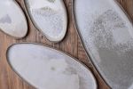Organic natural shape elongated stoneware plates in grey | Dinnerware by Laima Ceramics. Item made of stoneware compatible with minimalism and contemporary style