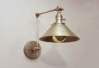 Swing Arm Adjustable Wall Light - Antique Brass | Sconces by Retro Steam Works. Item composed of metal compatible with industrial style