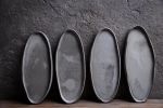 Organic natural shape elongated stoneware plates in grey | Dinnerware by Laima Ceramics. Item made of stoneware works with minimalism & contemporary style