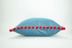 blue velvet pillow with red pom poms // blue and red pillow | Pillows by Velvet Fringe