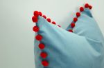 blue velvet pillow with red pom poms // blue and red pillow | Pillows by Velvet Fringe