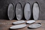 Organic natural shape elongated stoneware plates in grey | Dinnerware by Laima Ceramics. Item made of stoneware works with minimalism & contemporary style