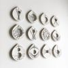 Stitched Ceramics - Set Of 12 | Wall Sculpture in Wall Hangings by Elizabeth Prince Ceramics. Item composed of stoneware compatible with mid century modern and contemporary style