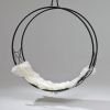 Studio Stirling Circular Wheel Chair in the POD Hotel | Swing Chair in Chairs by Studio Stirling | POD Camps Bay in Cape Town. Item composed of steel in minimalism or contemporary style