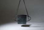 Genuine Leather Woven into a Hanging Swing Chair | Accent Chair in Chairs by Studio Stirling. Item made of steel & leather compatible with boho and minimalism style