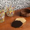 Wavy Brass Coasters with Rattan Holder (set of four) | Tableware by Hastshilp