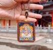 Artisan Manjushri Thangka Ash Clay Buddhist Amulet Pendant | Ornament in Decorative Objects by Dynasty Artisan. Item made of leather compatible with contemporary and eclectic & maximalism style