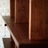 Custom Walnut Shelving Unit with Hidden Closet Door | Storage by Joe Cauvel of Cauv Design. Item made of walnut with steel