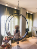 Modern Wheel in the Celebrity Edge Cruise | Swing Chair in Chairs by Studio Stirling. Item made of steel works with minimalism & coastal style