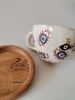 Extra Large Charming Handmade Evil Eye Cup With Saucer | Mug in Drinkware by HulyaKayalarCeramics. Item composed of wood & metal compatible with boho and mid century modern style