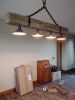 Reclaimed beam chandelier | Chandeliers by FrostCanyon Designs/Bo Sanders/the shop. Item made of wood with metal works with country & farmhouse & rustic style