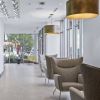 Custom Lobby Furniture (Sofas, Chairs, Tables) | Armchair in Chairs by Greg Sheres | Clippership Apartments on the Wharf in Boston. Item composed of fabric