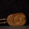 Carved Sandalwood & Deer Horn Deity Amulet Art | Ornament in Decorative Objects by Dynasty Artisan. Item made of wood works with contemporary & eclectic & maximalism style