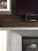 Cement and wood fireplace wall | Fireplaces by Kula Solutions. Item composed of wood and cement
