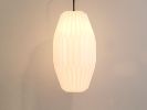 Gold floor lamp with a pleated oval long lampshade | Lamps by Studio Pleat. Item made of aluminum with paper works with minimalism & contemporary style
