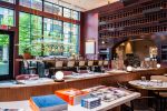 Collector's Bar Shelving | Storage by Amuneal | Lucian Books and Wine in Atlanta. Item made of wood with brass