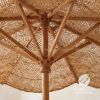 A large natural-fiber patio umbrella with a black base stan | Ornament in Decorative Objects by GoldencoirVietNam LLC. Item made of wood with fiber works with boho & country & farmhouse style