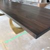 Charcoal walnut brass halo dining table | Tables by YJ Interiors. Item made of walnut with brass works with mid century modern & contemporary style