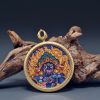 Handcrafted Blue Wealth Deity Thangka Amulet Pendant Art | Ornament in Decorative Objects by Dynasty Artisan. Item composed of metal in eclectic & maximalism or asian style