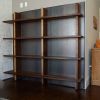Custom Walnut Shelving Unit with Hidden Closet Door | Storage by Joe Cauvel of Cauv Design. Item made of walnut with steel