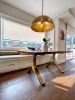 Black walnut dining table with brass wishbone legs | Tables by YJ Interiors. Item made of walnut with brass works with mid century modern & contemporary style