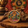 Tibetan Yellow Jambhala Thangka Wealth Amulet Pendant | Ornament in Decorative Objects by Dynasty Artisan. Item composed of metal in contemporary or eclectic & maximalism style