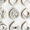 Stitched Ceramics - Set Of 12 | Wall Sculpture in Wall Hangings by Elizabeth Prince Ceramics. Item composed of stoneware compatible with mid century modern and contemporary style