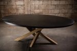 Oval Black Oak Dining Table, Criss Cross Golden Base | Tables by NO AGE FURNITURE STUDIO. Item composed of oak wood