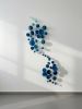 Blue cascade of circular epoxy resin sculpturar element | Mixed Media by Wall Art Object by Betti Brillembourg