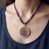 Handcrafted Blue Wealth Deity Thangka Amulet Pendant Art | Ornament in Decorative Objects by Dynasty Artisan. Item composed of metal in eclectic & maximalism or asian style