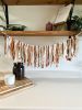 Hand-Ripped Fabric Tassel Garland | Tapestry in Wall Hangings by Over the Knotted Moon. Item made of fabric