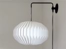 Industrial sconce with pleated elliptical lampshade | Sconces by Studio Pleat. Item made of metal with paper works with mid century modern & contemporary style