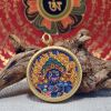 Handcrafted Blue Wealth Deity Thangka Amulet Pendant Art | Ornament in Decorative Objects by Dynasty Artisan. Item composed of metal in eclectic & maximalism or asian style