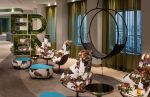 Modern Wheel in the Celebrity Edge Cruise | Swing Chair in Chairs by Studio Stirling. Item made of steel works with minimalism & coastal style