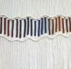 Macrame Wall Hanging with Jewel Tone Rainbow Accents | Wall Hangings by Q Wollock. Item composed of cotton