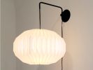 Industrial sconce with pleated elliptical lampshade | Sconces by Studio Pleat. Item made of metal with paper works with mid century modern & contemporary style