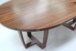 Oval walnut table, Trapeze leg, with book-matched top. | Tables by Jonathan Field