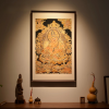 Framed Imperial Yunjin Silk Yellow Jambhala Thangka Art | Embroidery in Wall Hangings by Dynasty Artisan. Item composed of wood and fabric in contemporary or eclectic & maximalism style
