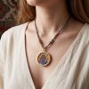 Handcrafted Blue Wealth Deity Thangka Amulet Pendant Art | Ornament in Decorative Objects by Dynasty Artisan. Item composed of metal in eclectic & maximalism or asian style