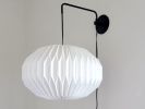 Industrial sconce with pleated elliptical lampshade | Sconces by Studio Pleat. Item made of metal with paper works with mid century modern & contemporary style