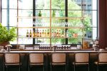 Collector's Bar Shelving | Storage by Amuneal | Lucian Books and Wine in Atlanta. Item made of wood with brass