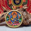 Tibetan Yellow Jambhala Thangka Wealth Amulet Pendant | Ornament in Decorative Objects by Dynasty Artisan. Item composed of metal in contemporary or eclectic & maximalism style