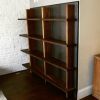 Custom Walnut Shelving Unit with Hidden Closet Door | Storage by Joe Cauvel of Cauv Design. Item made of walnut with steel